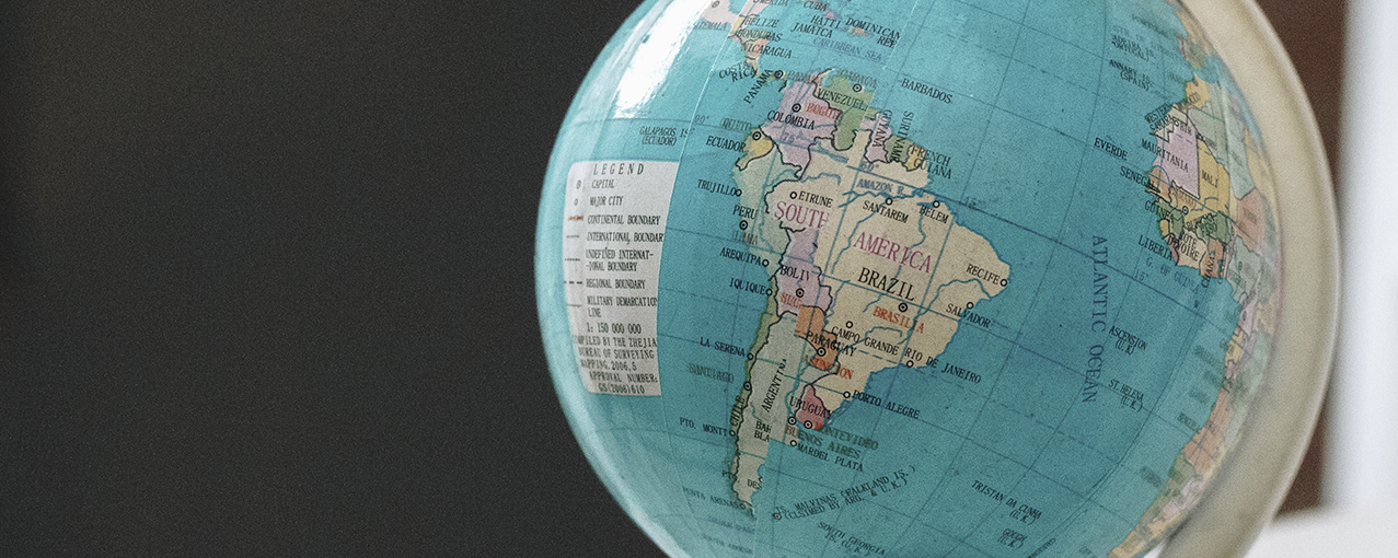 A imagem mostra um globo terrestre, com destaque para a América do Sul